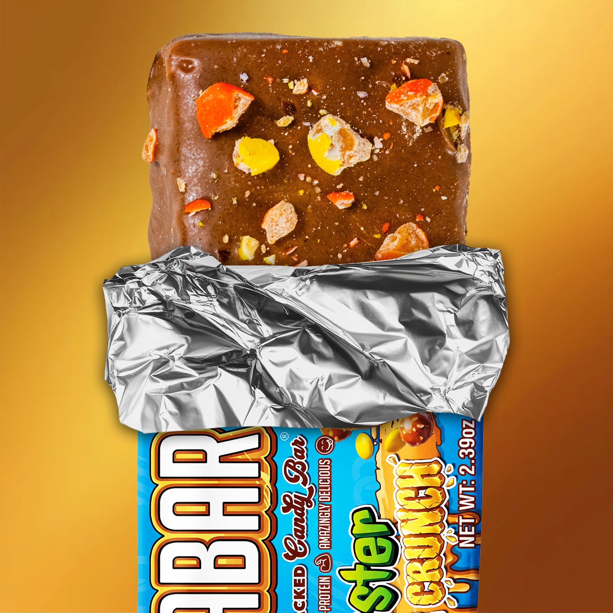 The Anabar Monster Cookie Crunch is a milk chocolate protein bar with colorful candy pieces, partially unwrapped from silver foil and a blue wrapper, set against a golden-yellow backgroundโideal for Monster Cookie Crunch fans.
