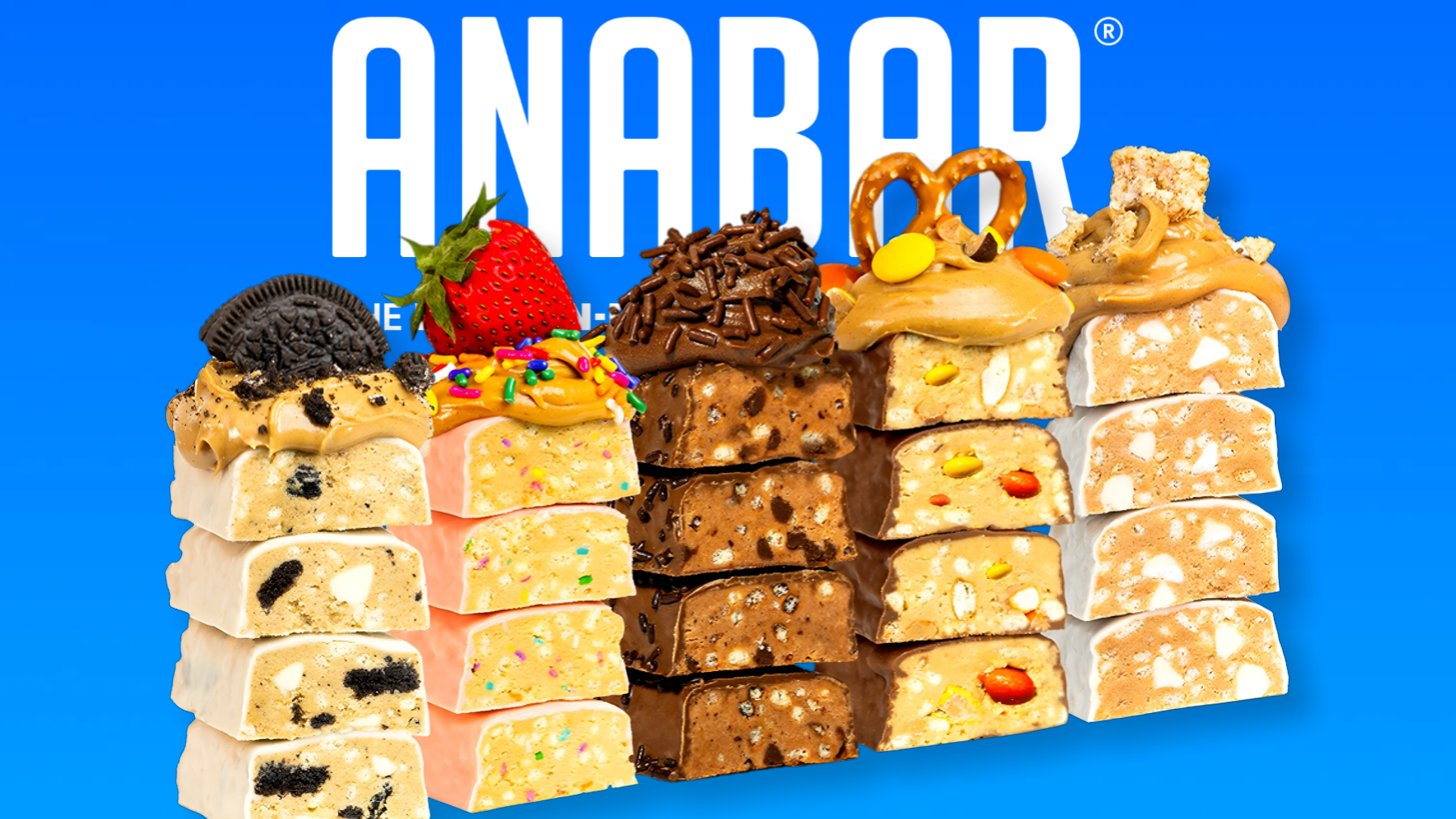 Colorful stacked protein bars with various toppings, including cookies, strawberries, sprinkles, pretzels, and peanuts, arranged against a blue background with the text "ANABAR" at the top.