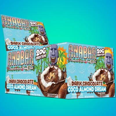 Boxes of The Anabar Coco Almond Dream protein bars, featuring palm trees, coconuts, chocolate, and a smiling statue on the packaging, are displayed against a blue background. Each bar contains 20g of protein.