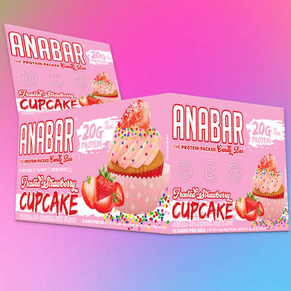 Displayed on a colorful gradient background are two boxes of The Anabar's Frosted Strawberry Cupcake protein bars. Each box showcases a cupcake with strawberries, sprinkles, and the text "20 Grams of Protein.