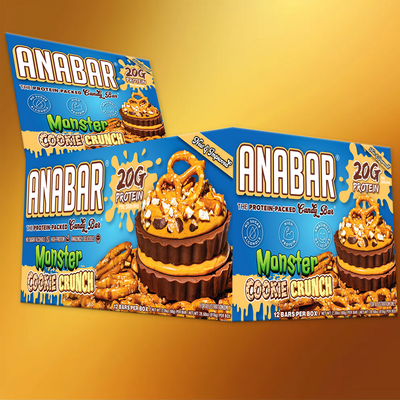 Two blue boxes of The Anabar Monster Cookie Crunch, each with 12 bars, showcase a milk chocolate bar layered with peanut butter, pretzels, and cookie bits. "20g Protein" is highlighted on a golden yellow label.