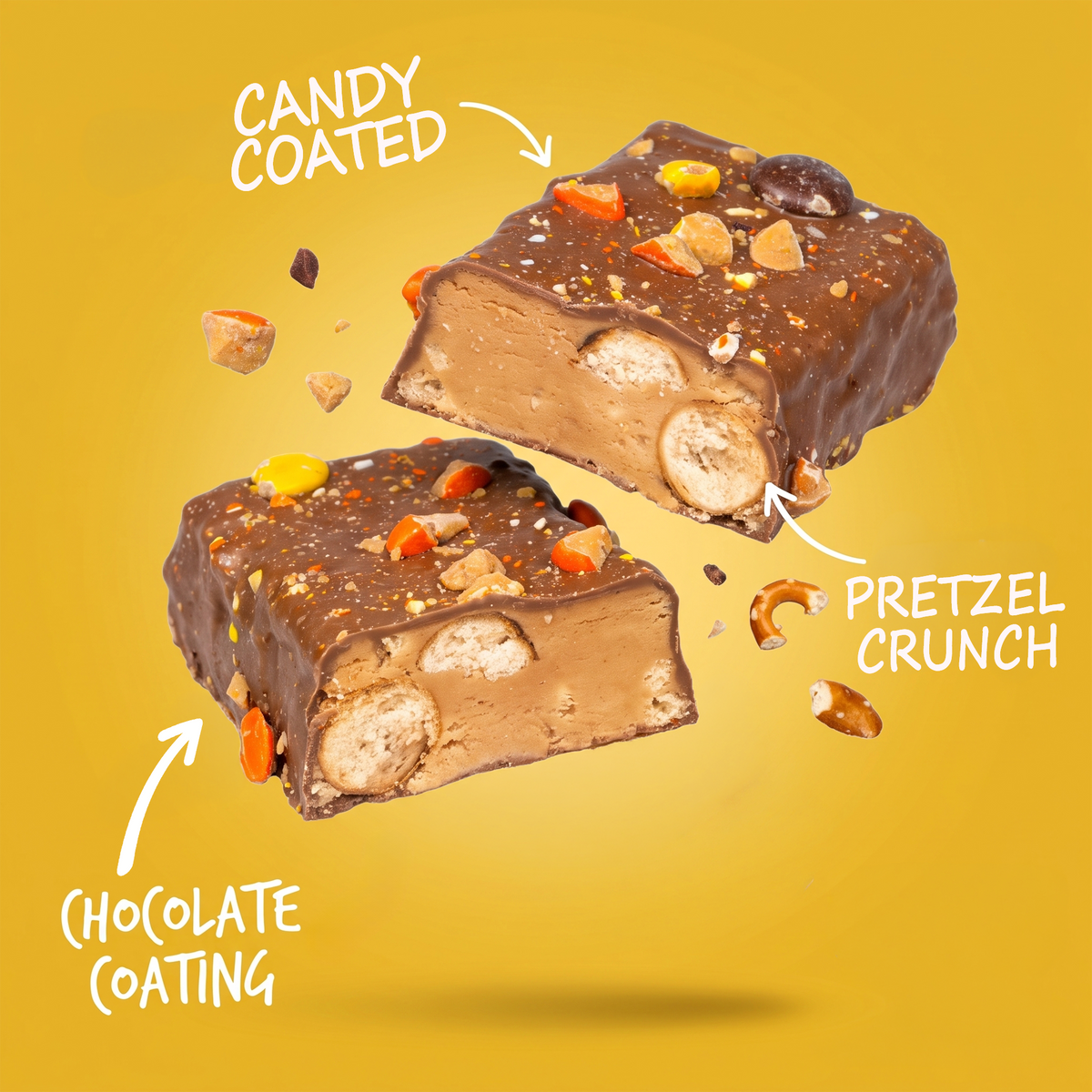 Two halves of a Monster Cookie Crunch protein bar with candy-coated pieces and pretzel bits, with arrows pointing to the ingredients and labels reading “Candy Coated,” “Pretzel Crunch,” and “Chocolate Coating.”