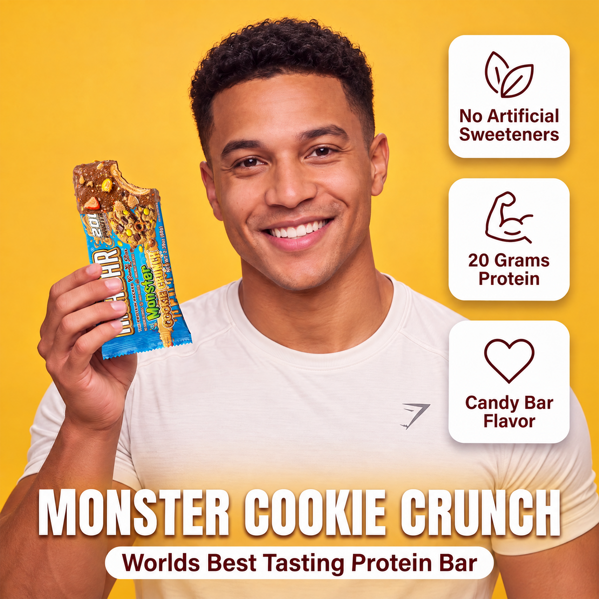 A smiling man holds a partially eaten The Anabar Monster Cookie Crunch protein bar, with icons highlighting no artificial sweeteners, 20 grams of protein, and the flavor name.